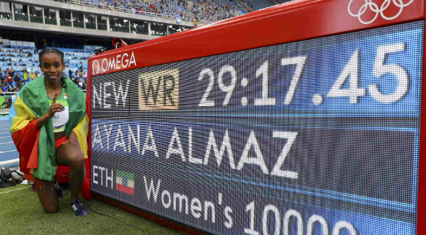 Almaz Ayana (ETH) of Ethiopia poses for photographers after setting a new world record.