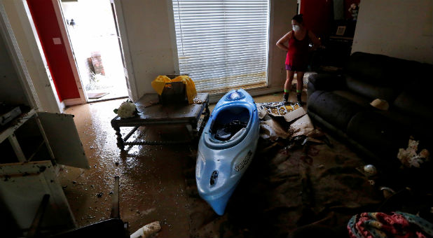 Johnette Folse stands in her flood damaged living room in Denham Springs, Louisiana, U.S.