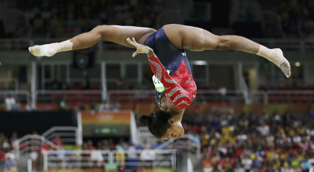 Gabrielle Douglas (USA) of USA (Gabby Douglas) competes on the beam during the women's qualifications.