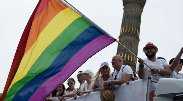People dance in front of the Victory column as they participate in the annual Gay Pride parade, also called Christopher Street Day parade (CSD), in Berlin, Germany.