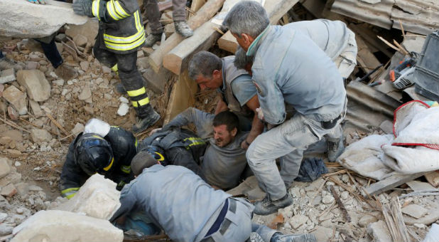 A man is rescued alive from the ruins following an earthquake in Amatrice, central Italy
