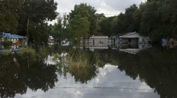 Floodwaters cover streets of a residential area in Sorrento, Louisiana