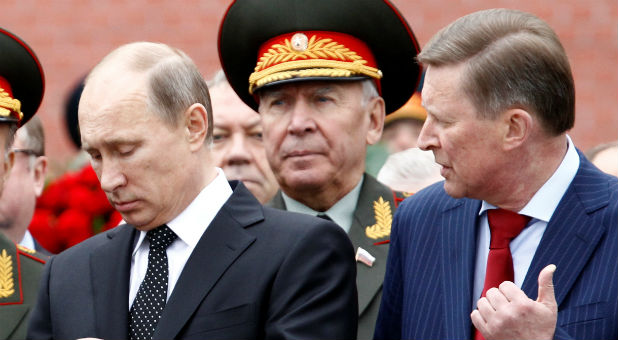 Russian President Vladimir Putin (L) and chief of President's staff Sergei Ivanov attend a ceremony marking the 72nd anniversary of the Nazi German invasion, at the Tomb of the Unknown Soldier by the Kremlin walls in Moscow, Russia