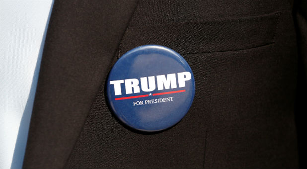 A member of the U.S. Republican party's election campaign team in Israel wears a badge of Republican U.S. presidential nominee Donald Trump during a campaign aimed at potential American voters living in Israel