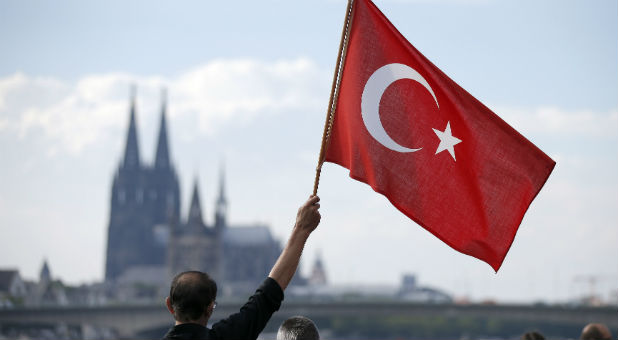 A supporter of Turkish President Tayyip Erdogan waves a Turkish flag during a pro-government protest