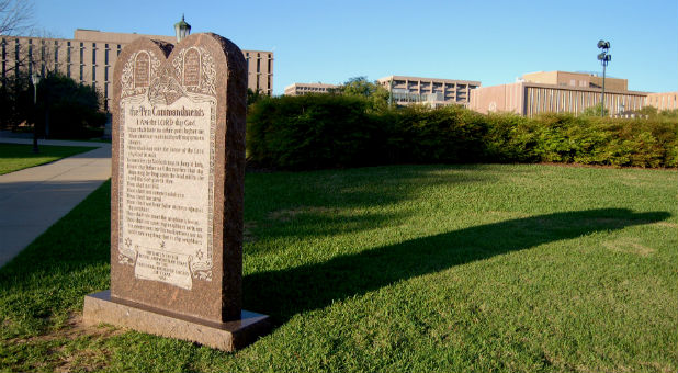 A Ten Commandments monument on the grounds of the Allegany County courthouse that is nearly identical to one the U.S. Supreme Court upheld in 2005 will stay in place after the offended person who sued to uproot it dropped his lawsuit Tuesday.