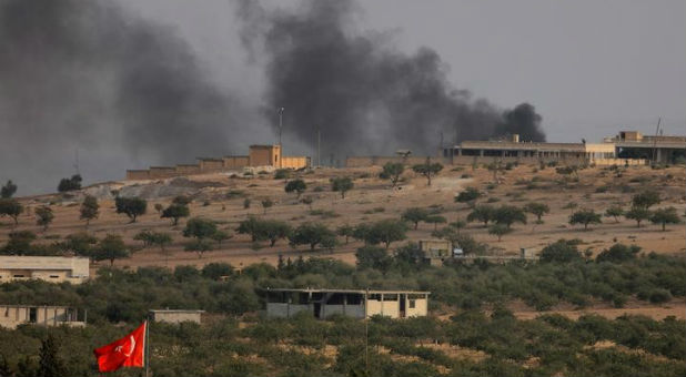 Smoke rises from the Syrian border town of Jarablus as it is pictured from the Turkish town of Karkamis, in the southeastern Gaziantep province, Turkey