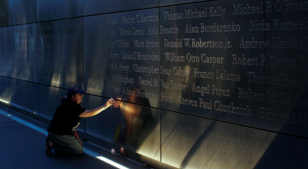 A mourner honors the memory of the victims of 9/11 at the Empty Sky memorial in New Jersey.