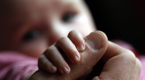 Baby Holding Thumb
