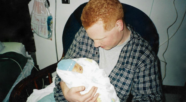 Kevin Crawford holds his son, Joshua.