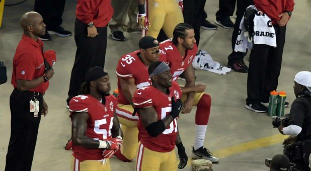 San Francisco 49ers quarterback Colin Kaepernick (7) and free safety Eric Reid (35) kneel during the playing of the national anthem before a NFL game against the Los Angeles Rams at Levi's Stadium