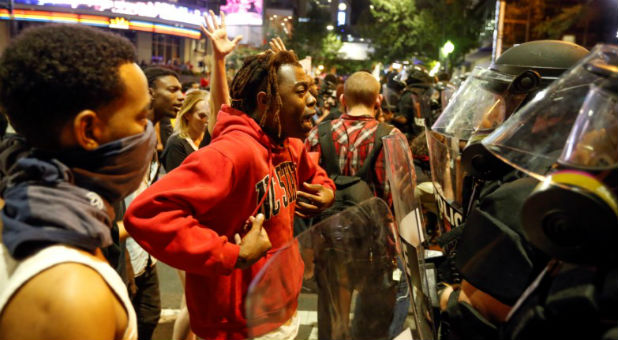 A man speaks to police in uptown Charlotte, NC during a protest of the police shooting of Keith Scott, in Charlotte.