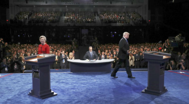Republican U.S. presidential nominee Donald Trump and Democratic U.S. presidential nominee Hillary Clinton walk on the stage during their first presidential debate at Hofstra University in Hempstead
