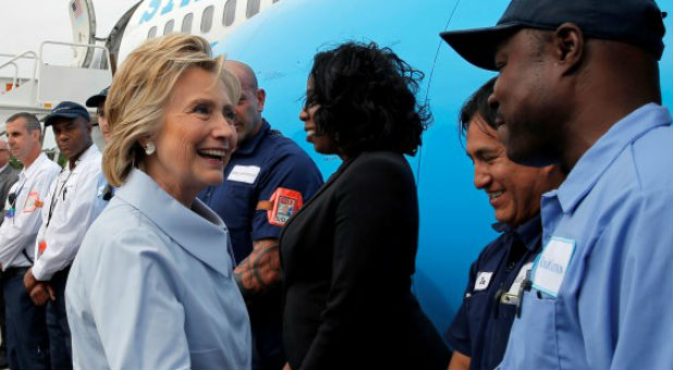 U.S. Democratic presidential nominee Hillary Clinton greets flight crew and others before boarding her newly unveiled campaign plane for the first time at the Westchester County Airport in White Plains, New York
