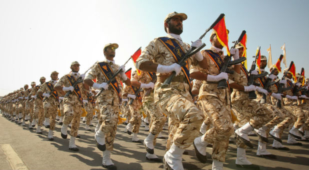 Members of the Iranian revolutionary guard march during a parade to commemorate the anniversary of the Iran-Iraq war