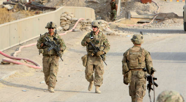 U.S. soldiers walk on a bridge within the town of Gwer in northern Iraq.