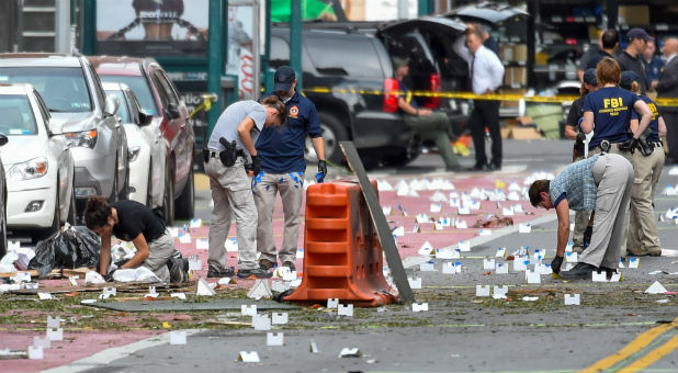 Federal Bureau of Investigation (FBI) and other security officials mark evidence near the site of an explosion that took place on Saturday night in the Chelsea neighborhood of Manhattan, New York