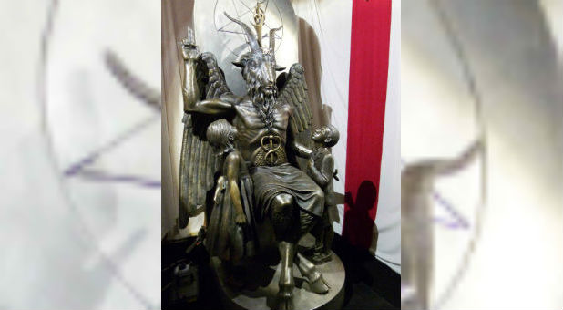 A one-ton, 7-foot (2.13-m) bronze statue of Baphomet -- a goat-headed winged deity that has been associated with satanism and the occult -- is displayed by the Satanic Temple during its opening in Salem, Massachusetts