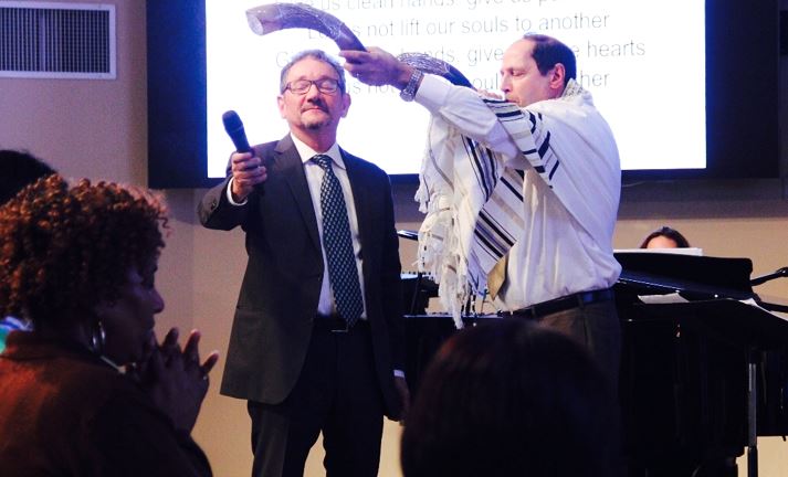 Grant Berry (left) oversees the shofar proclamation during the Rosh Hashanah service at Messiah's House.