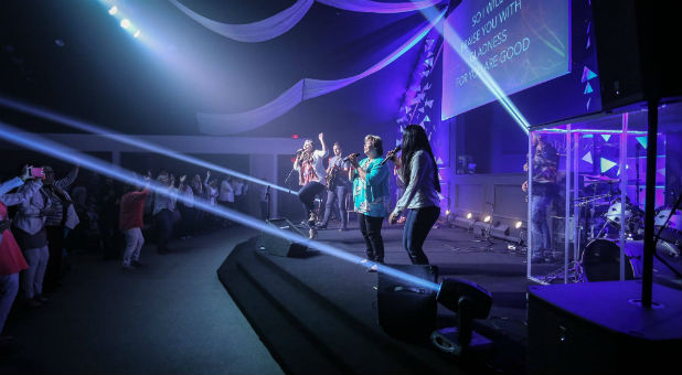 People worship at a New Creation Church service.
