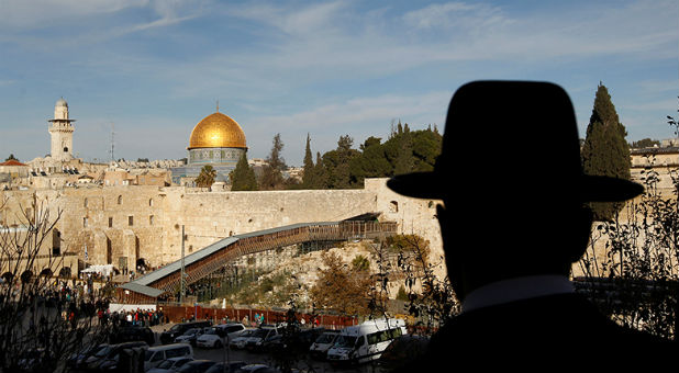 An ultra-Orthodox Jewish man stands at a point overlooking a wooden ramp leading up from Judaism's Western Wall to the sacred compound known to Muslims as the Noble Sanctuary and to Jews as Temple Mount, where the Al-Aqsa mosque and the Dome of the Rock shrine stand, in Jerusalem's Old City