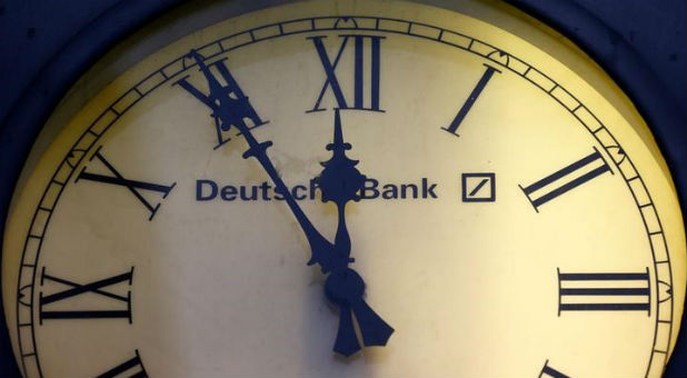 A vintage clock with the logo of Deutsche Bank is pictured outside the bank's branch in Wiesbaden, Germany