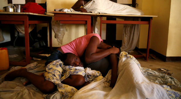 People sleep on the floor in a partially destroyed school used as a shelter after Hurricane Matthew hit Jeremie, Haiti