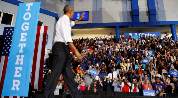 U.S. President Barack Obama waves to supporters as he takes the stage to speak at a Clinton-Kaine campaign rally at Florida Memorial University in Miami, Florida.
