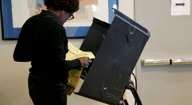 A woman prepares to cast her vote.