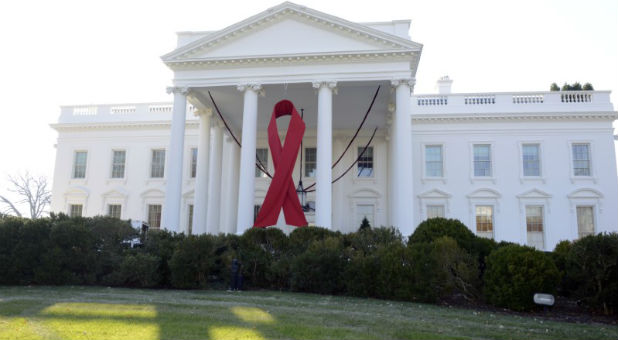 A giant red ribbon hangs from the North Portico of the White House to mark World AIDS Day.