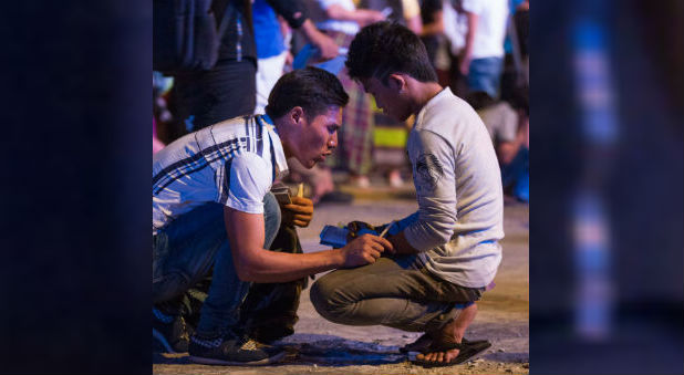 A trained counselor prays with a young adult who came forward after Franklin Graham led the crowd in a prayer of salvation.