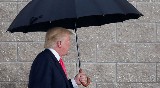 Republican presidential nominee Donald Trump arrives in the rain for a campaign rally in Tampa, Florida.