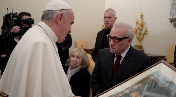 Pope Francis receives a gift from film director Martin Scorsese during a private audience at the Vatican