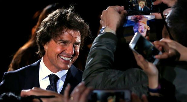 Actor Tom Cruise talks with fans as he attends the Japan premiere of the film