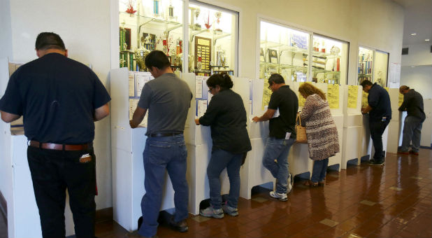 People cast their ballots next to a trophy wall at a high school gymnasium during voting in the 2016 presidential election in San Ysidro, California