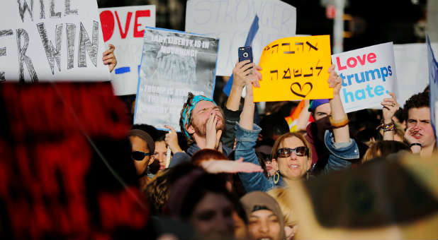 People take part in a protest against Republican president-elect Trump at the Washington Square park in the neighborhood of Manhattan in New York.