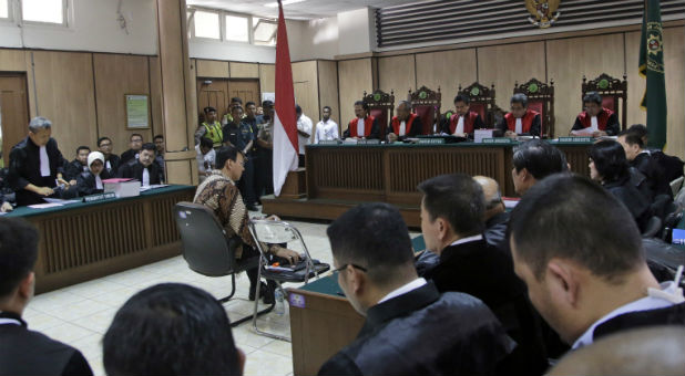 Jakarta Governor Basuki Tjahaja Purnama, popularly known as Ahok, sits on the defendant's chair at the start of his trial hearing at North Jakarta District Court in Jakarta, Indonesia