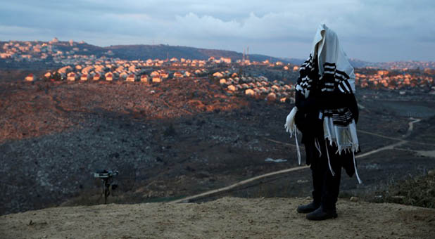 Jew Wearing a Prayer Shawl on Hill Overlooks West Bank Settlement