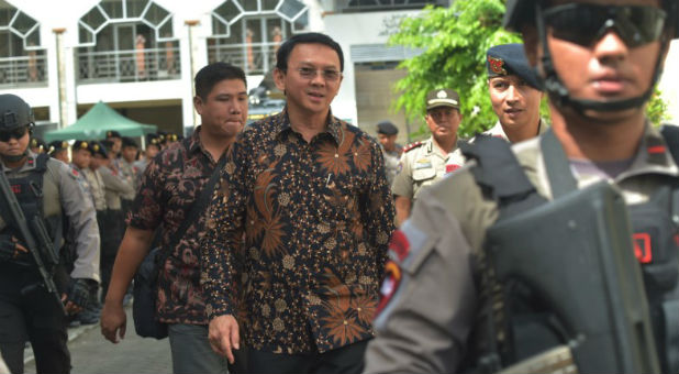 Jakarta's Christian governor Basuki Tjahaja Purnama, alias Ahok, is escorted by anti-terror policemen as he leaves the North Jakarta court