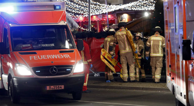 Rescue workers stand near the Christmas market in Berlin, Germany
