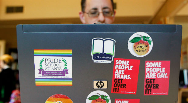 Director and Co-Founder Christian Zsilavetz, of the Pride School does work from his computer covered in stickers