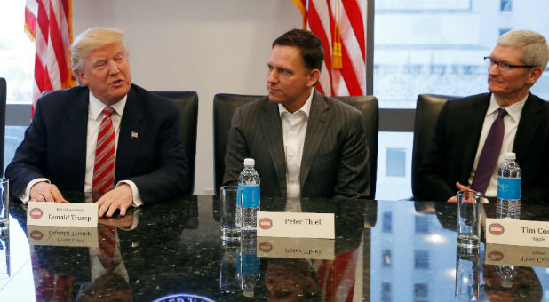 U.S. President-elect Donald Trump speaks while PayPal co-founder and Facebook board member Peter Thiel and Apple Inc CEO Tim Cook look on during a meeting with technology leaders at Trump Tower