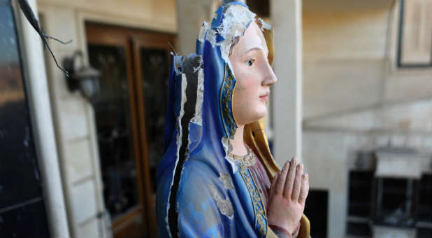 A damaged statue of the Virgin Mary is seen in a church in Qaraqosh.