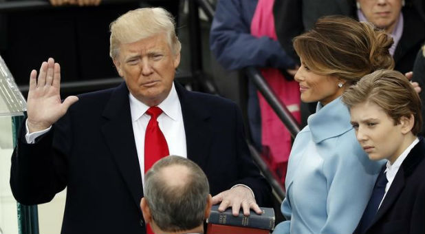 Donald Trump takes the oath of office with his wife, Melania, and son Barron at his side, during his inauguration at the U.S. Capitol in Washington