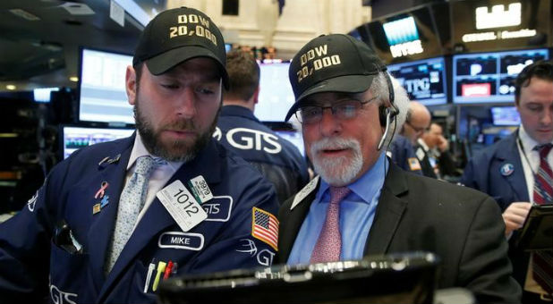 Traders work on the main trading floor of the NYSE as the Dow Jones Industrial Average passes 20,000 after opening of trading session in New York