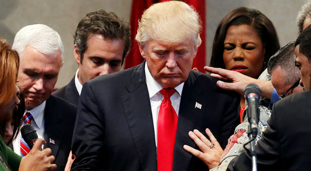 Members of the clergy lay hands and pray over Republican presidential nominee Donald Trump