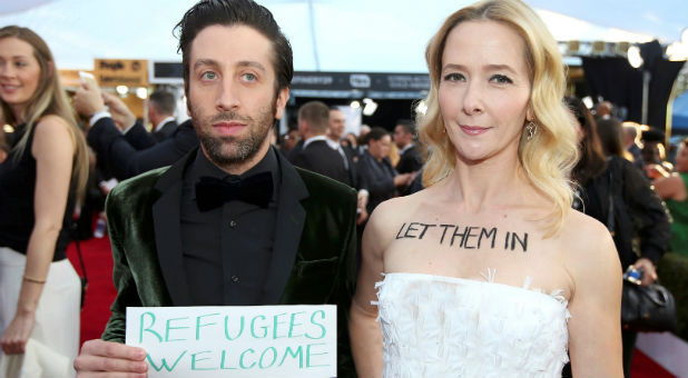 Actor Simon Helberg and his wife, actress Jocelyn Towne, make a political statement about the current U.S. restriction on refugees as they arrive at the 23rd Screen Actors Guild Awards