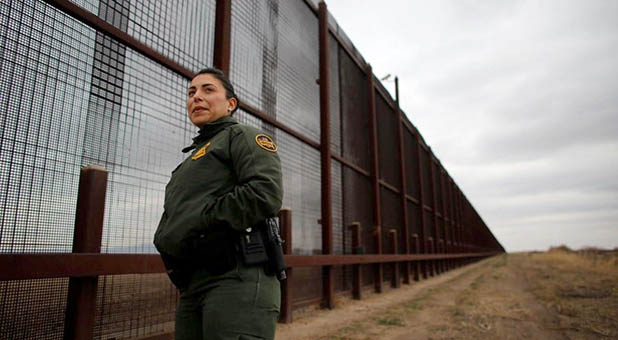 Border Patrol Officer at Border Fence Near El Paso, Texas