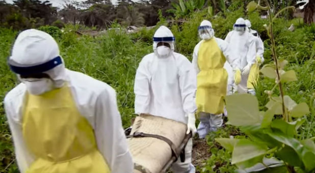 Volunteers carry the body of a victim attacked by Ebola.