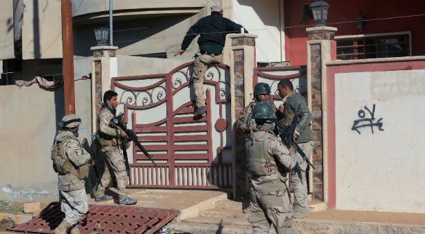 Iraqi army soldiers search a house for Islamic State militants and improvised explosive devices (IEDs) north of Mosul, Iraq, Jan.19, 2017.